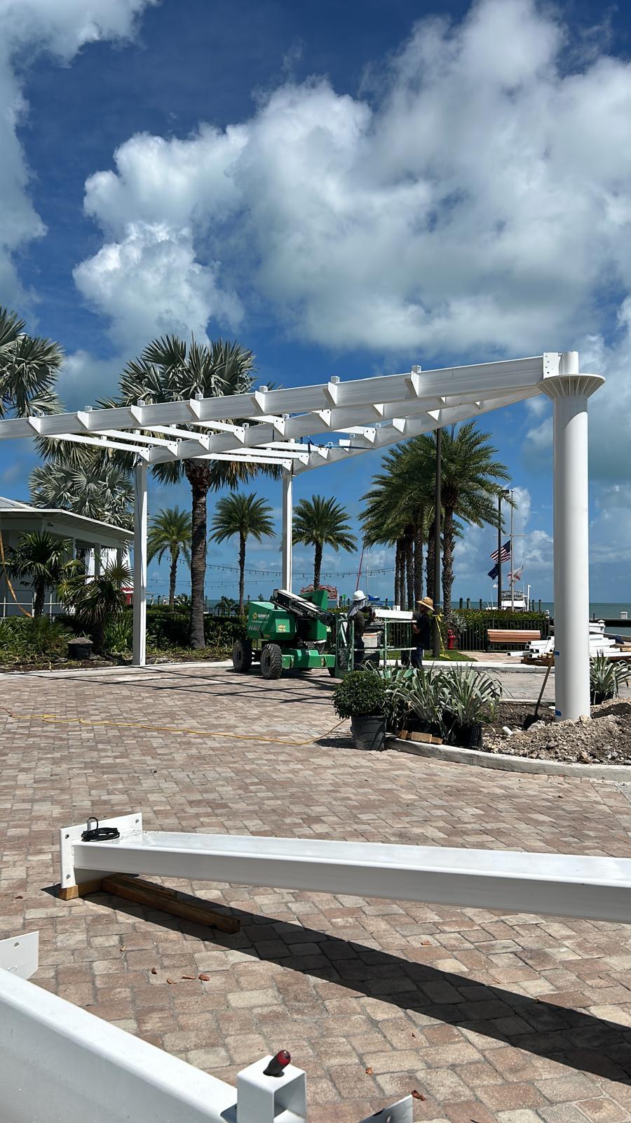 White-finished metal entrance structure with glass roof in Miami